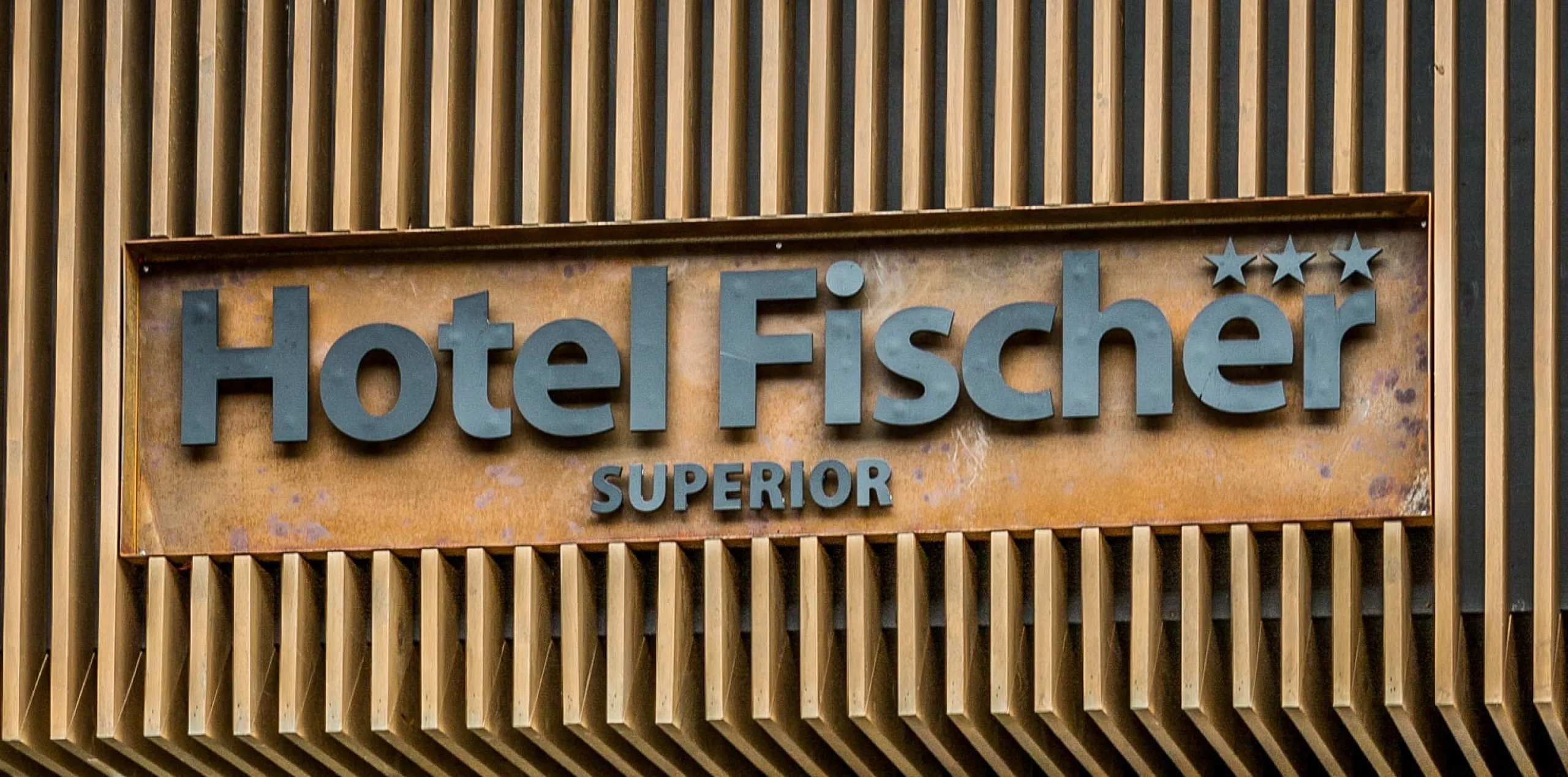 Sign of Hotel Fischer with star ratings